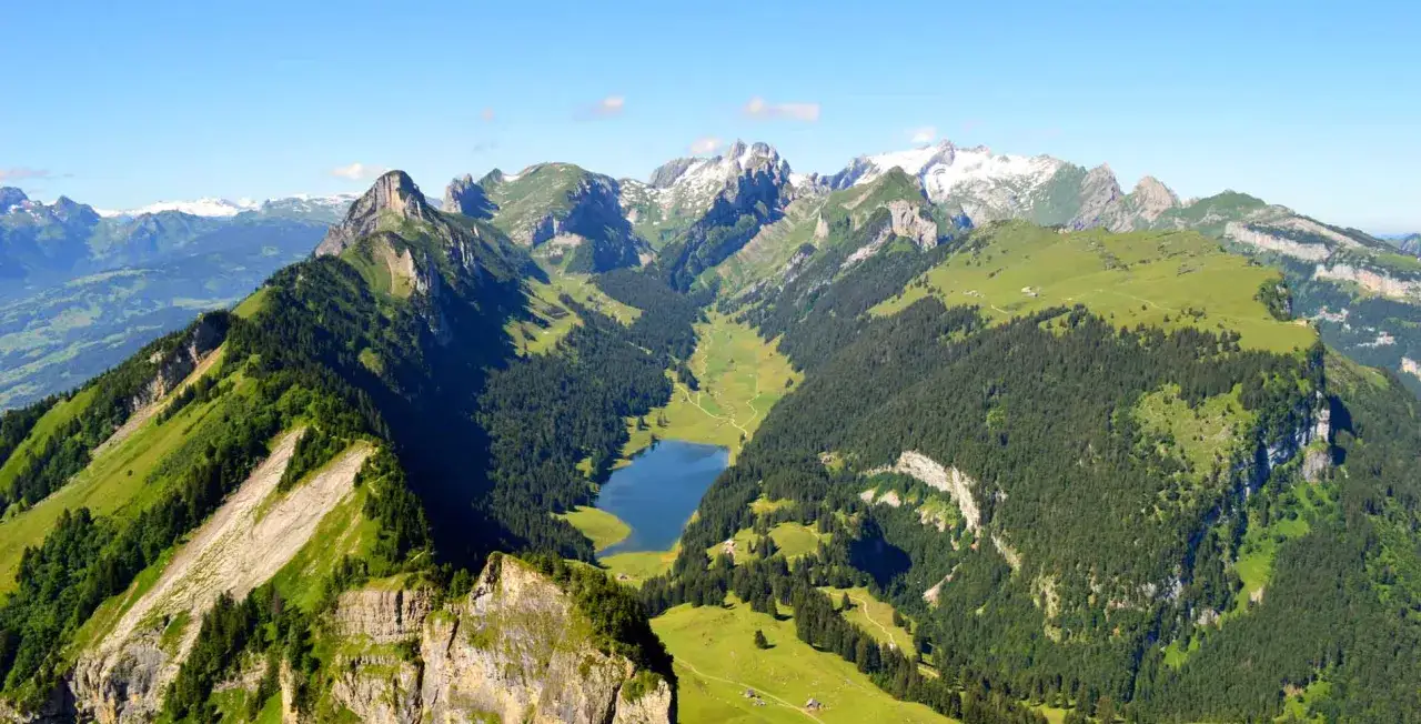 Atemberaubende Aussicht auf eine Berglandschaft mit einem See und gr&uuml;nen H&auml;ngen, ideal f&uuml;r eine **hoher kasten wanderung**.