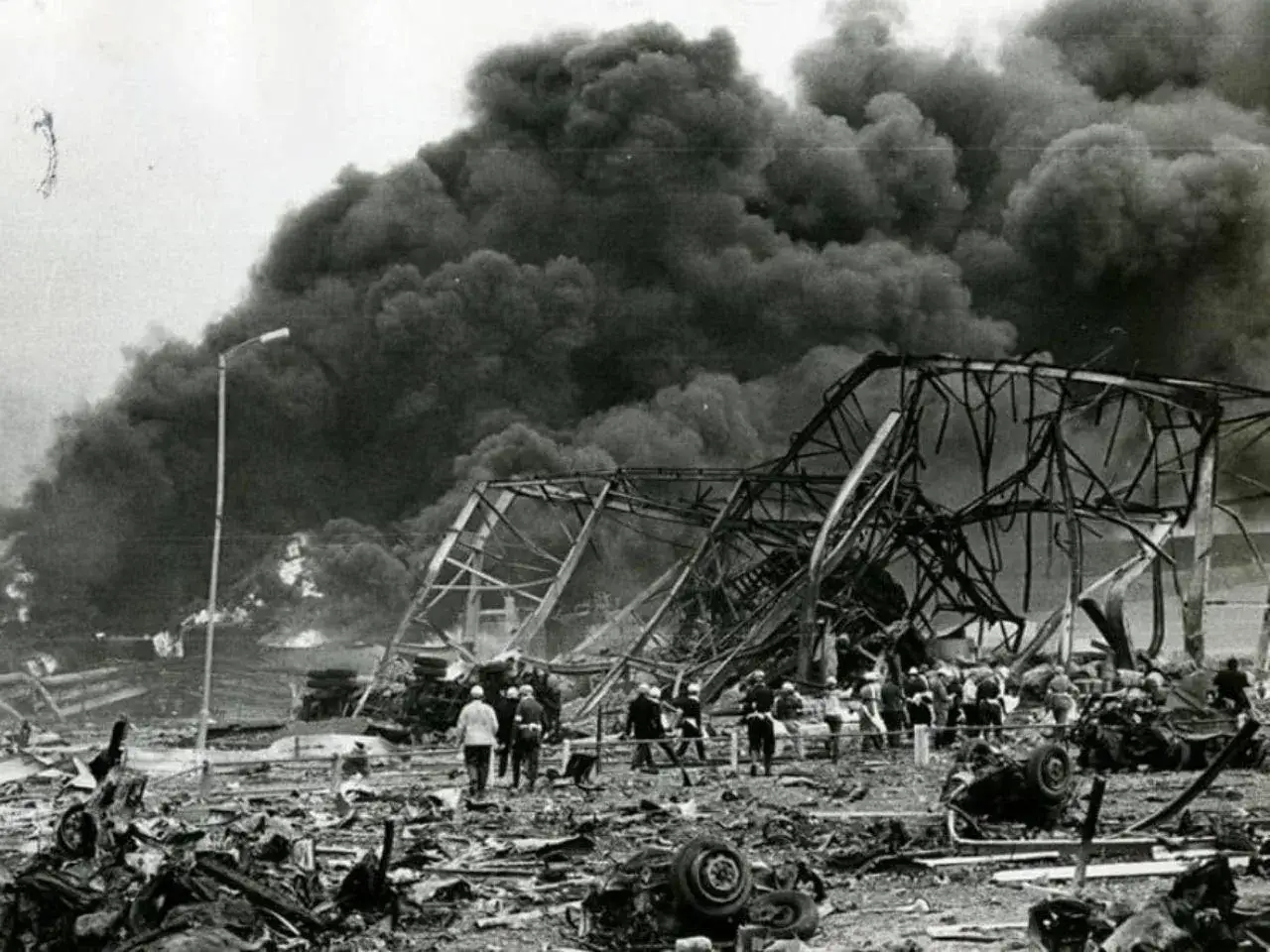 Czarnobyl kiedy: zniszczony budynek, kłęby czarnego dymu, gruzy i ludzie w hełmach.