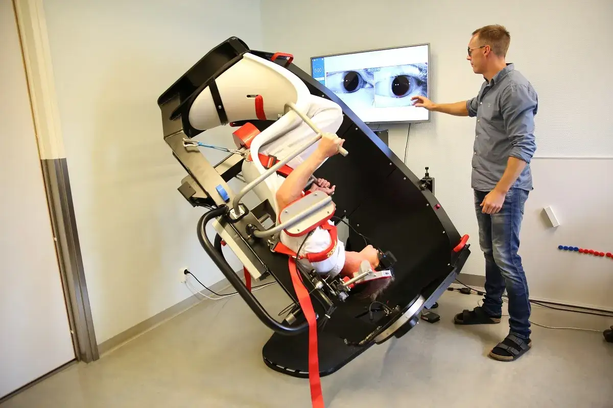 Man unders&ouml;ker &ouml;gonr&ouml;relser p&aring; en patient i en maskin. Detta kan vara en del av en behandling eller diagnostik f&ouml;r massage mot yrsel.