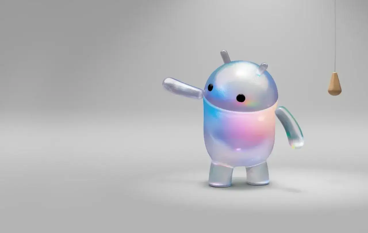 Przezroczysty robot z tęczowymi refleksami, przypominający maskotkę aplikacji Gemini, wita Cię w cyfrowym świecie.