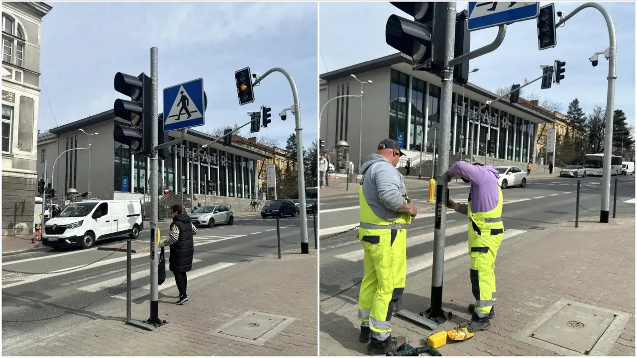 Pracownicy montują sygnalizację świetlną przy przejściu dla pieszych.