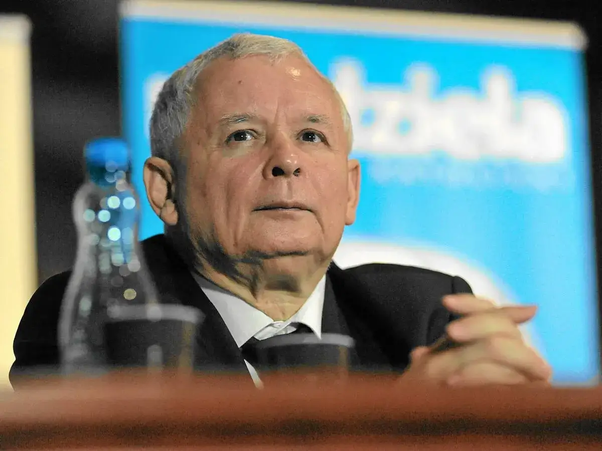 Jarosław Kaczyński, polityk, siedzi przy stole. Wzrost i waga polityka są tematem dyskusji.