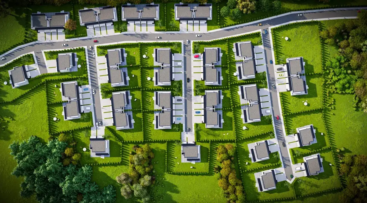 Jak narysować plan osiedla? Widok z lotu ptaka na nowoczesne domy szeregowe, drogi i zieleń.