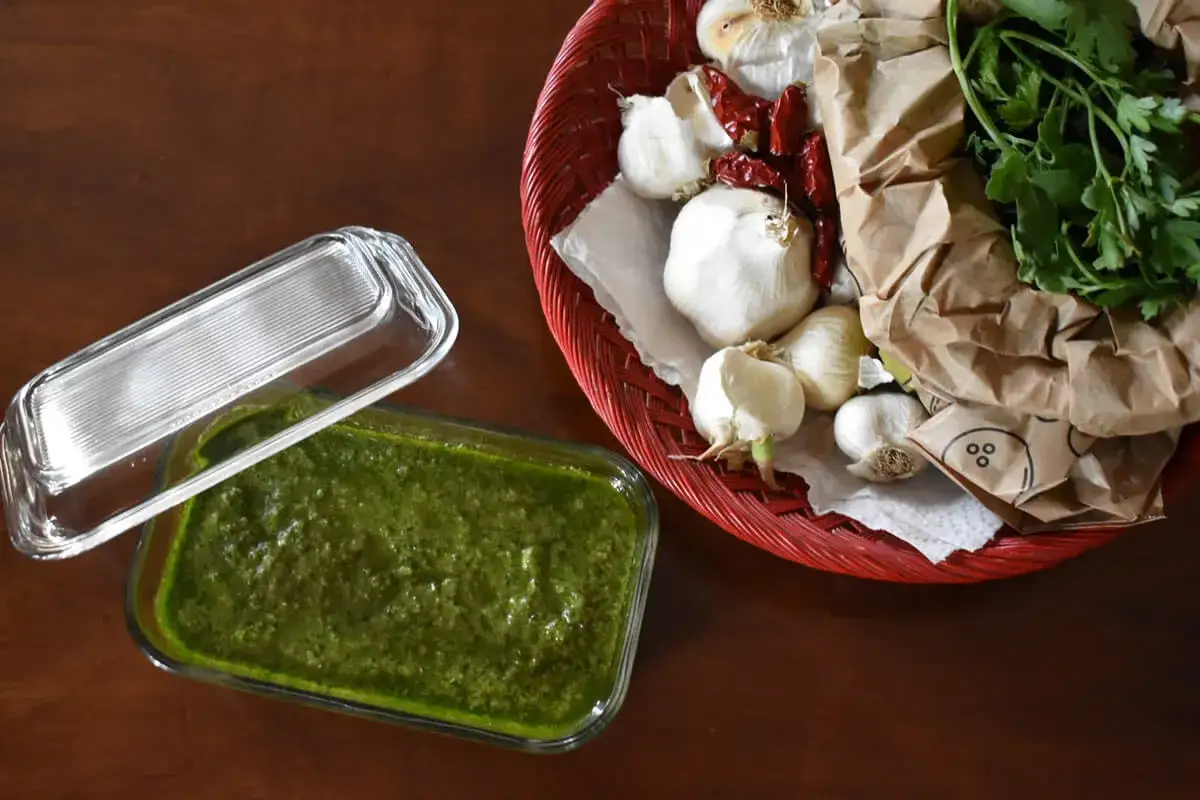 Salsa verde ricetta: ingredienti freschi come aglio, peperoncino e prezzemolo pronti per essere trasformati in una gustosa salsa.