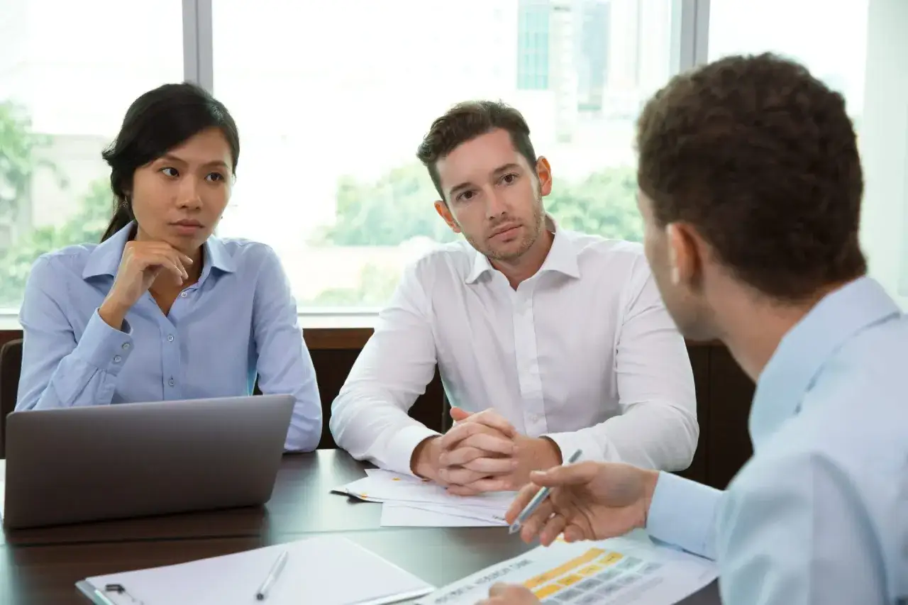 Team meeting discussing strategies for employee engagement after layoffs.