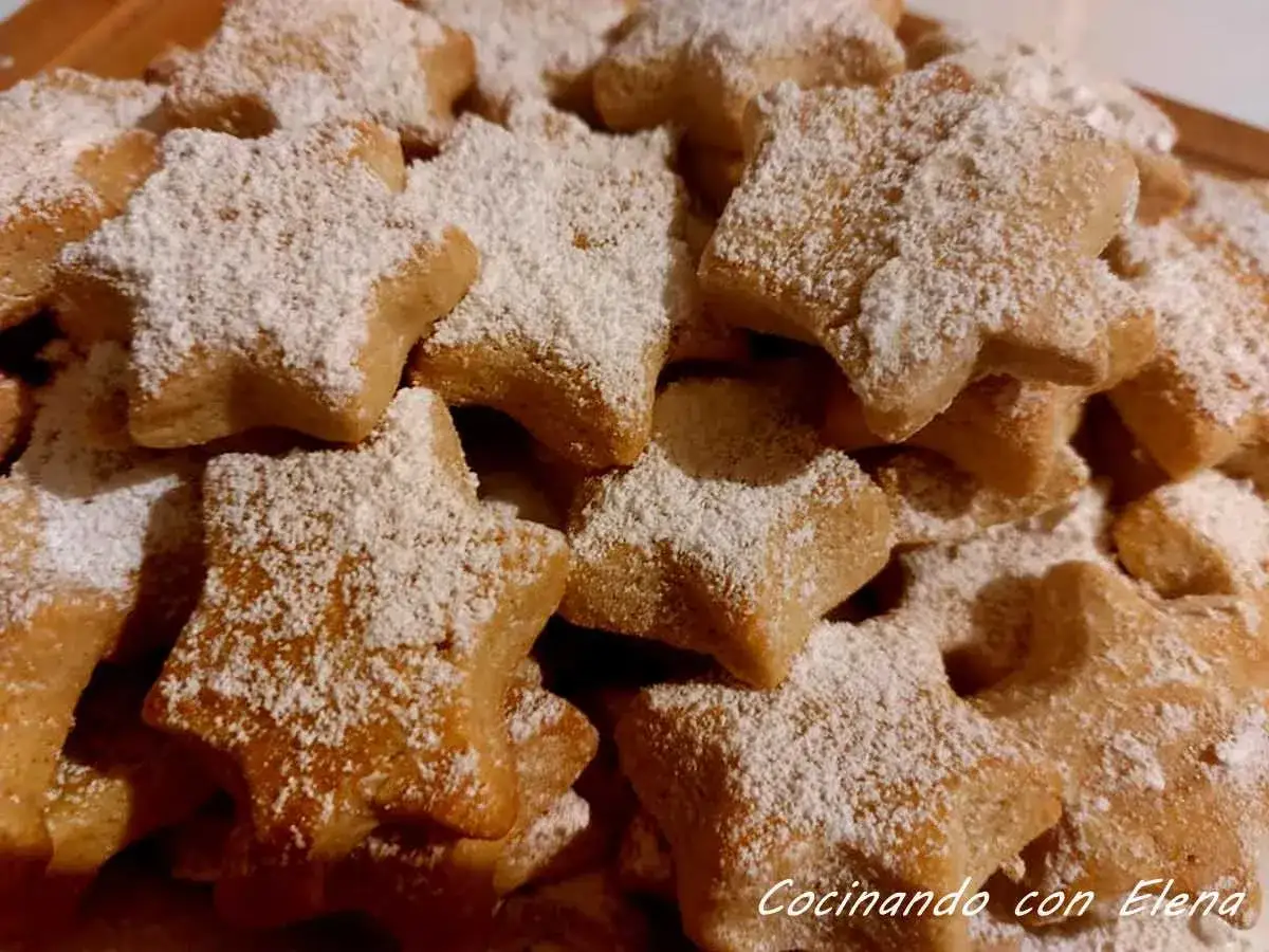 Deliciosas galletas caseras de pueblo con forma de estrella, espolvoreadas con azúcar glas. Perfectas para acompañar un café.