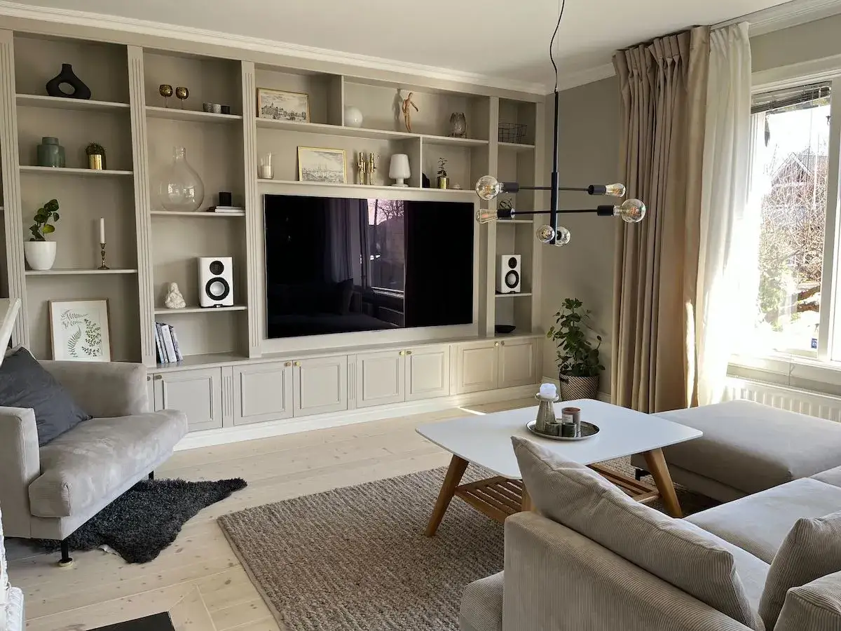 Inbyggd bokhylla inspiration med TV, h&ouml;gtalare och dekorativa f&ouml;rem&aring;l. En stilren och funktionell l&ouml;sning f&ouml;r vardagsrummet.