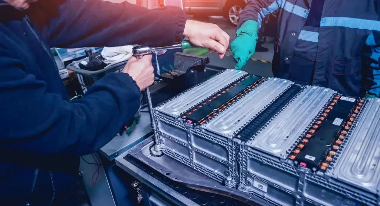 Mekniker arbetar med service elbil batteripaket.