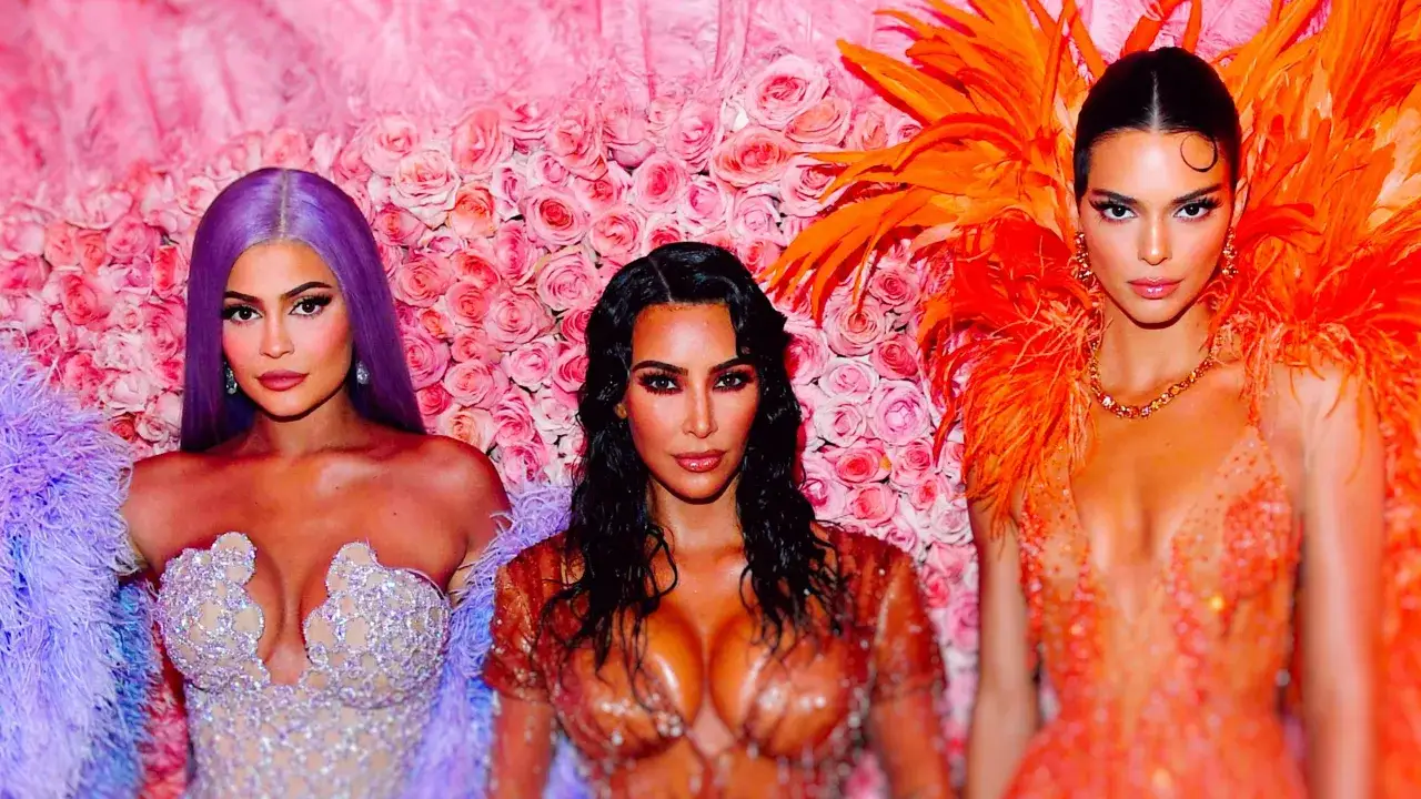 Kylie Jenner, Kim Kardashian, and Kendall Jenner pose at the Met Gala, a night of high fashion and glamour.