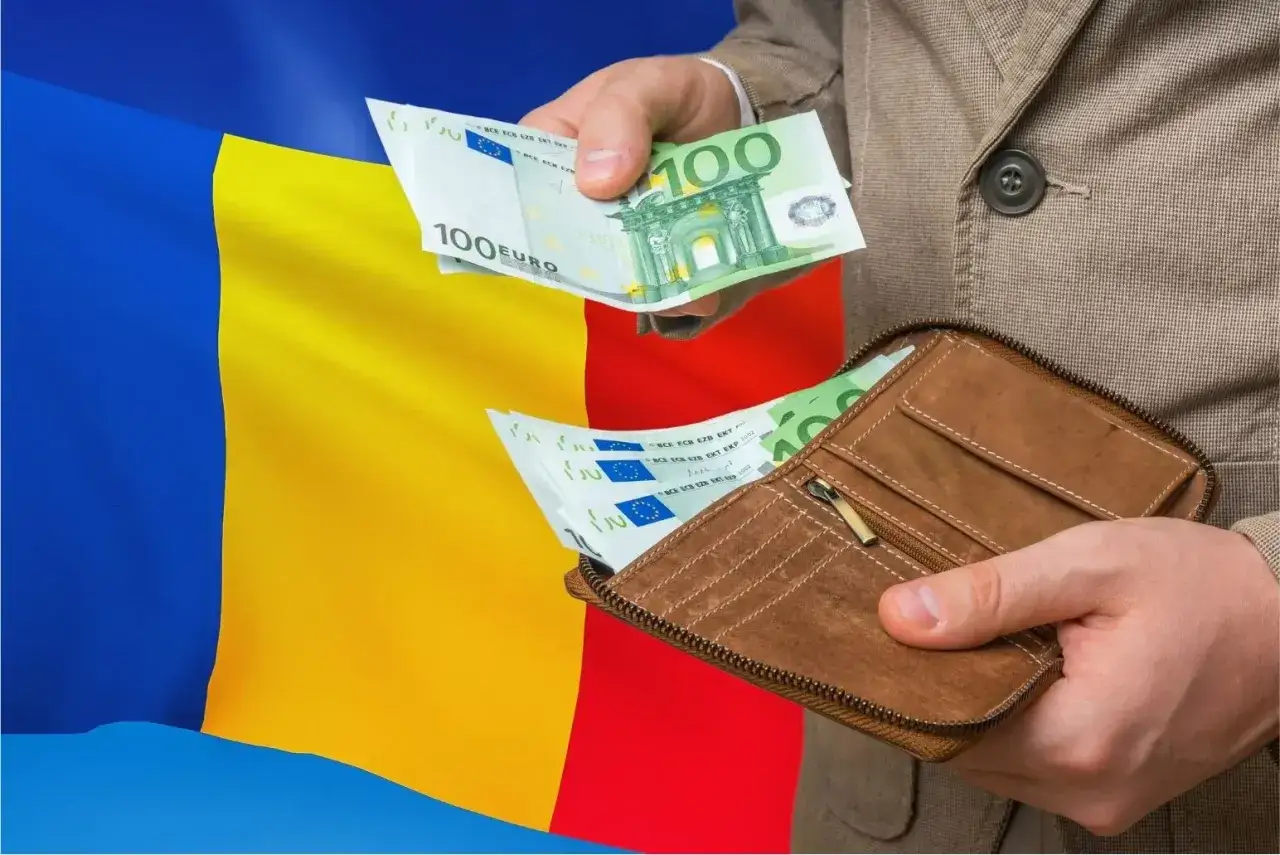 Ręce wkładają euro do portfela na tle flagi Rumunii. Czy do Rumunii potrzebny jest paszport? Pieniądze i podróże.