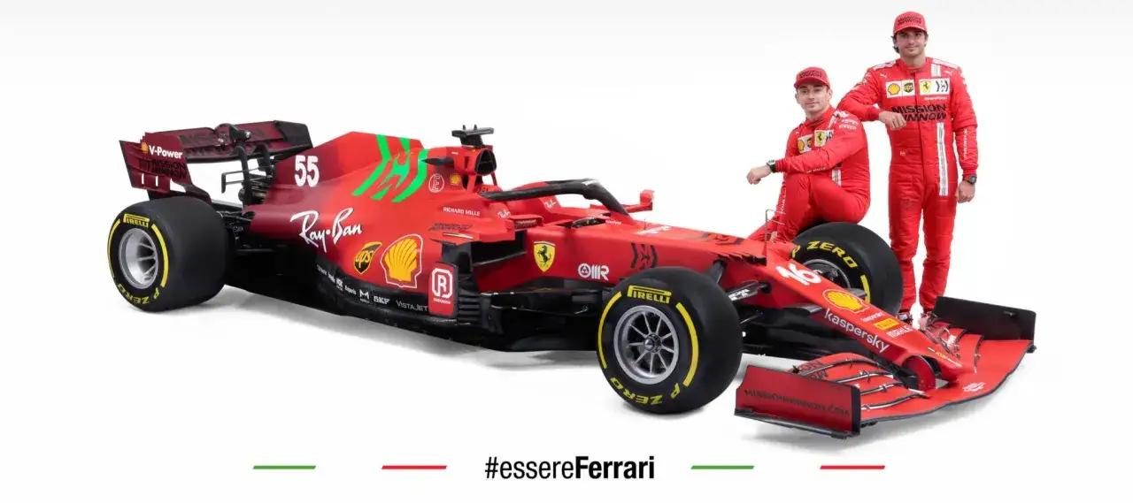 Carlos Sainz y Charles Leclerc posan junto a un coche de Ferrari.