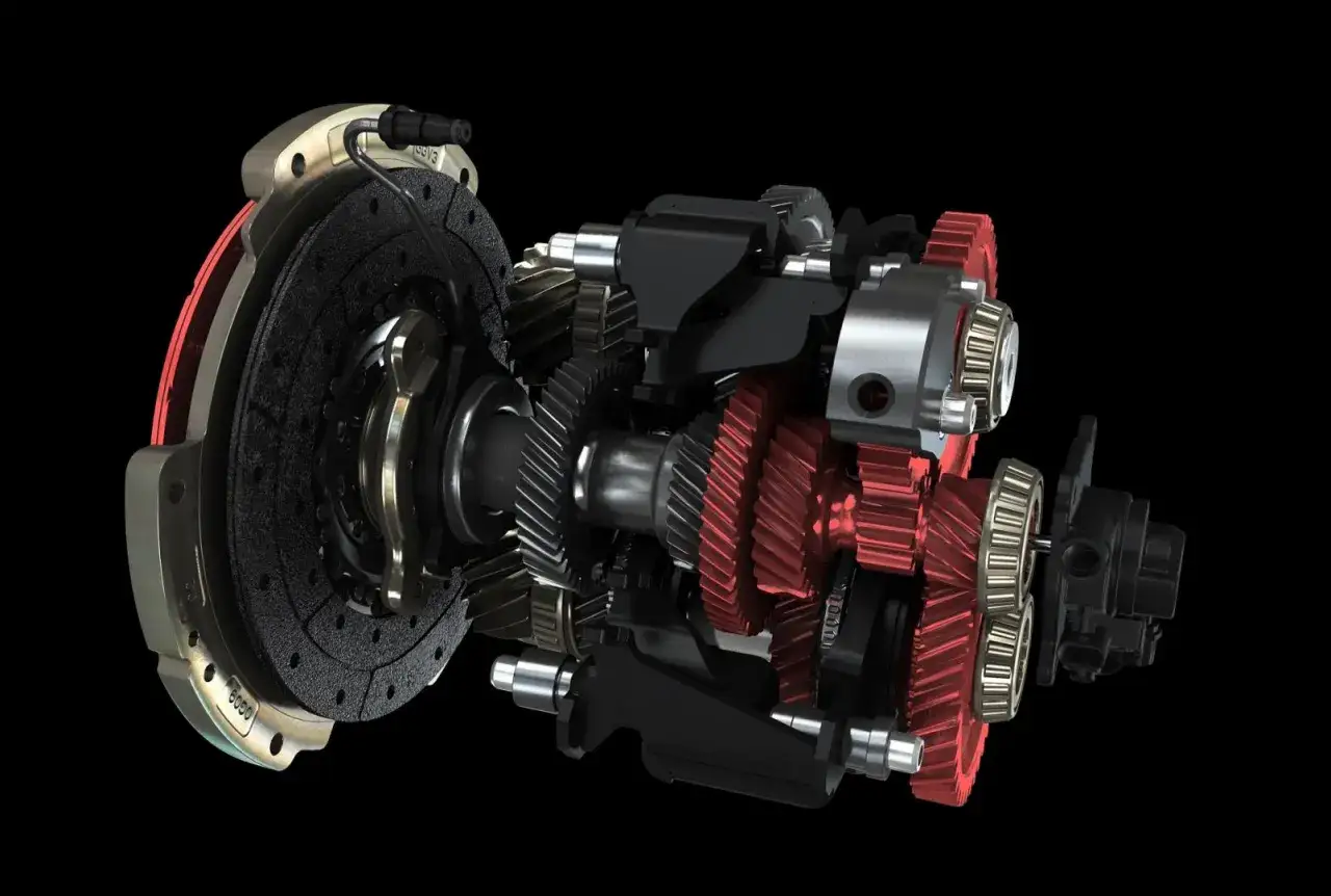 Przekładnia z czerwonymi zębatkami i tarczą sprzęgła, ukazująca mechanizm płynnej zmiany biegów (powershift).