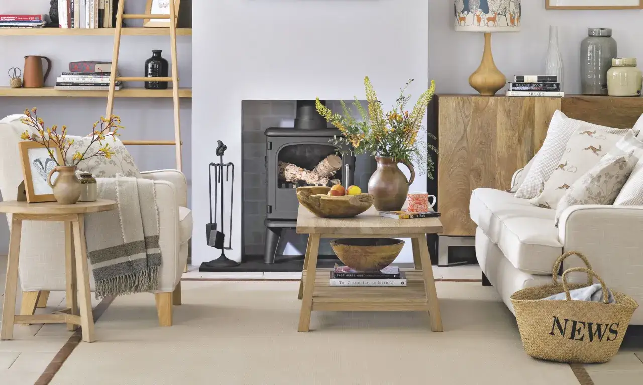 Cozy living room with country contemporary furniture, a wood-burning stove, and a basket labeled
