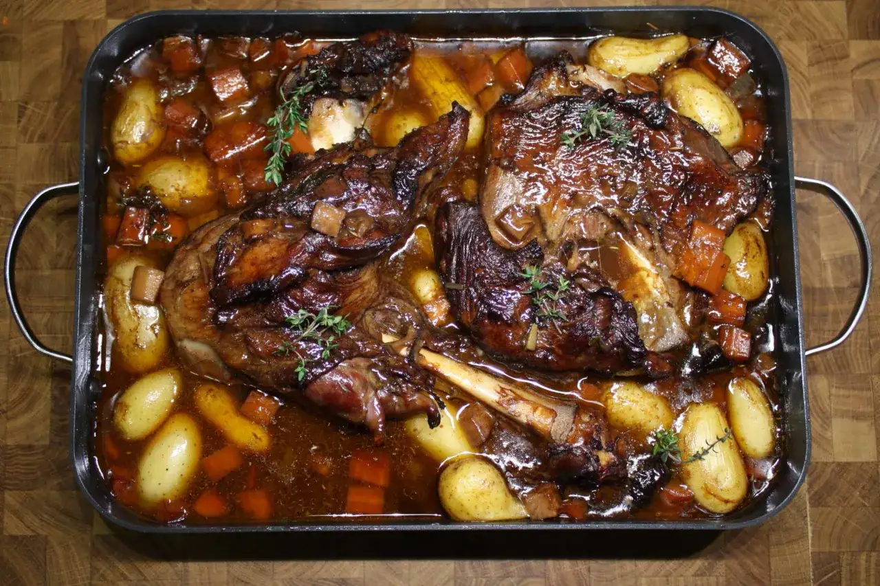 Zwei saftige Lammkeulen, geschmort mit Kartoffeln und Karotten in einer dunklen Sauce. Ein köstliches Lammschulter Rezept, das zum Genießen einlädt.
