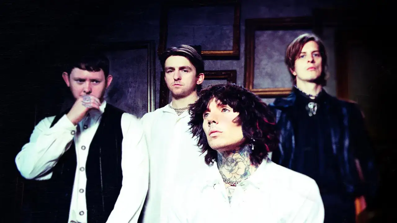 Czterech członków zespołu Bring Me The Horizon w stylizowanych strojach, gotowych na koncert w Polsce.