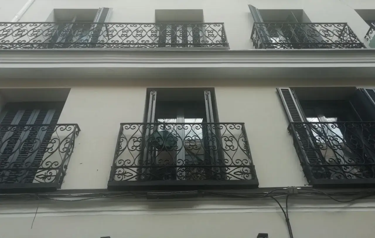Fachada de edificio con balcones de hierro forjado, parte de un proyecto de rehabilitación de edificios antiguos.