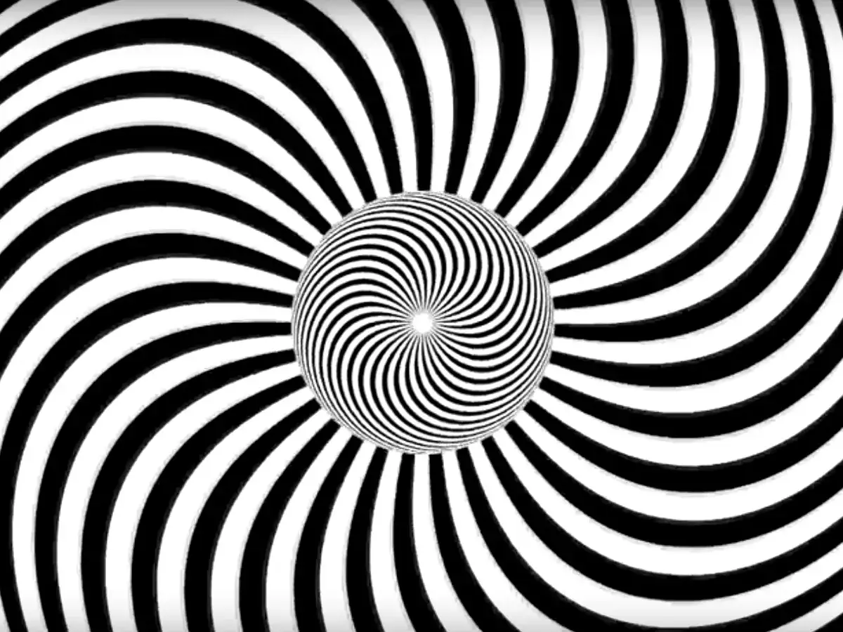 Iluzja optyczna z czarno-białymi spiralami, przypominająca zagadkę brakującego kwadratu.
