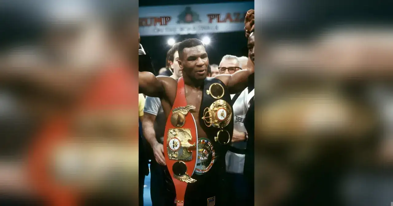 Mike Tyson prime, a champion with multiple belts, raises his arms in victory.