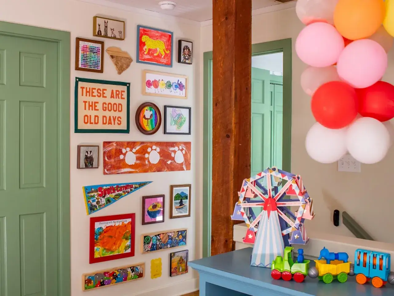 A vibrant kids art gallery wall showcases colorful drawings, paw prints, and a 