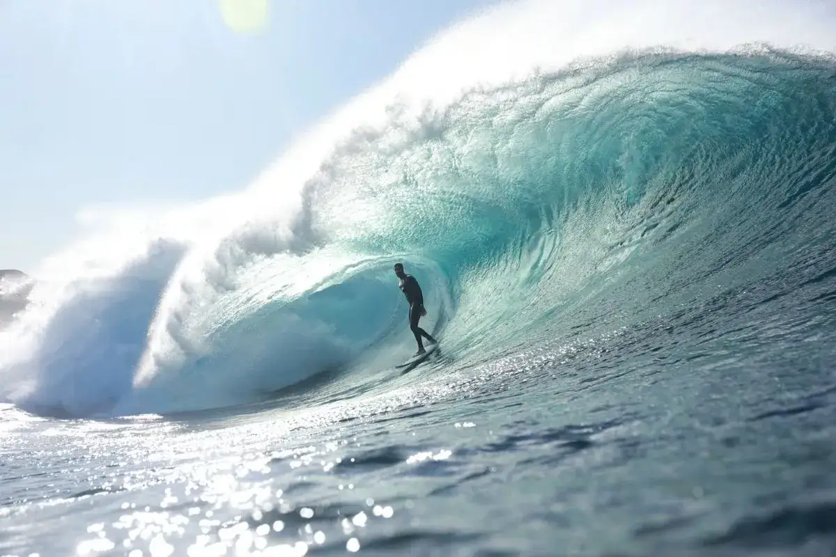 Surfer reitet eine massive Welle in einem Tunnel, ein Traum f&uuml;r jeden, der Surfen auf den Kanaren liebt.