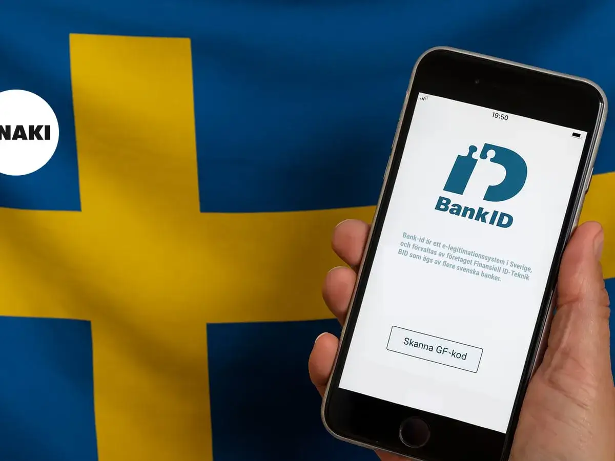 En mobiltelefon visar BankID-appen framför en svensk flagga. Frågan