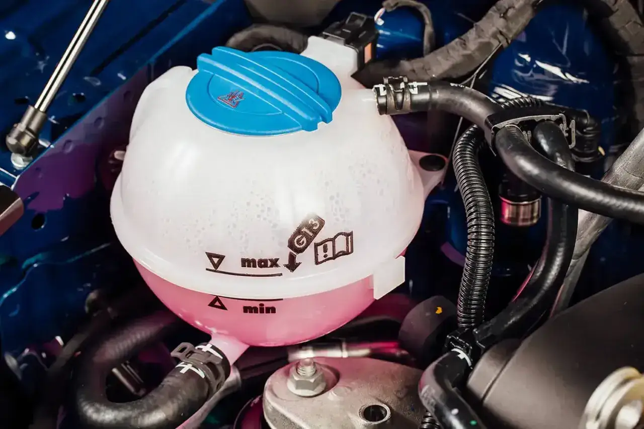 Coolant reservoir with G13 marking. Check the max/min lines to see what coolant your car needs.
