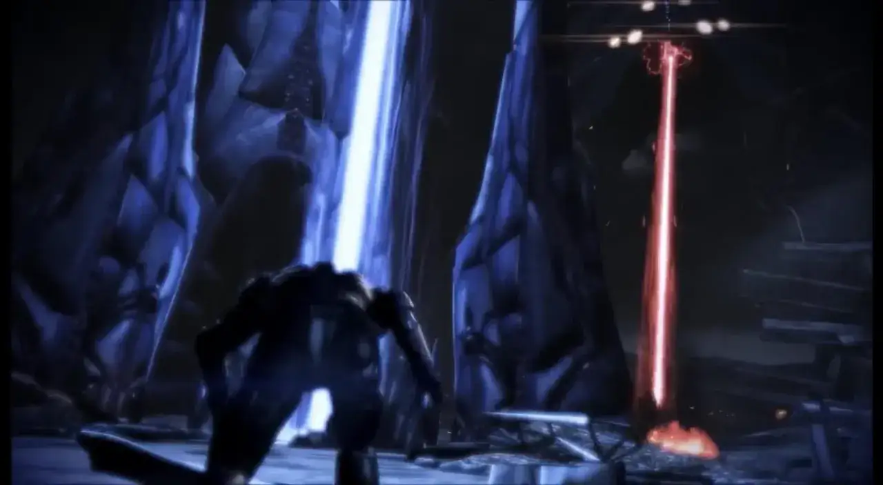 Postać w zbroi pochyla się pod wpływem czerwonego promienia w mrocznym, futurystycznym otoczeniu. Scena z gry Mass Effect 3.