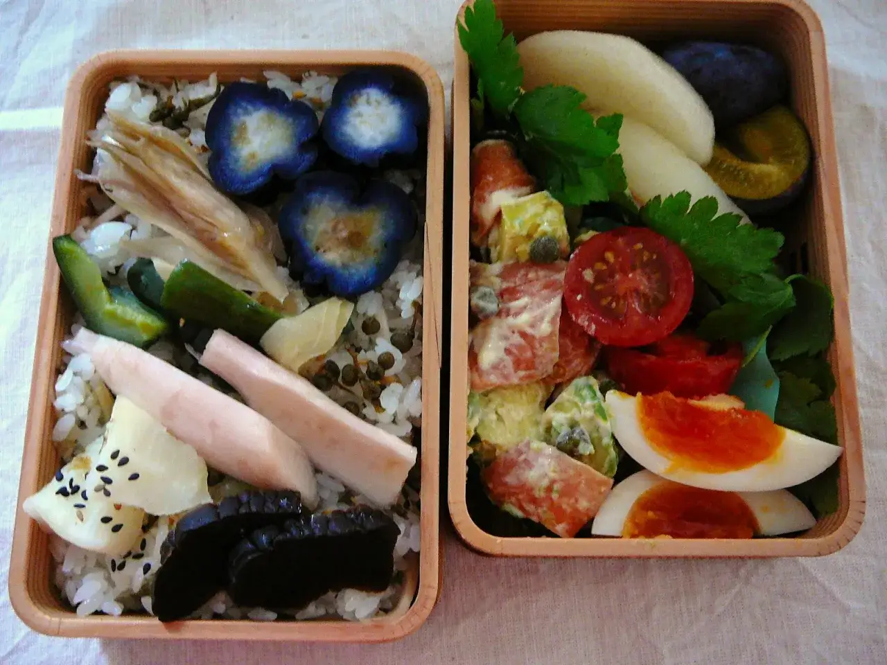 A delicious curry bento box with rice, pickled vegetables, and a side salad with egg.