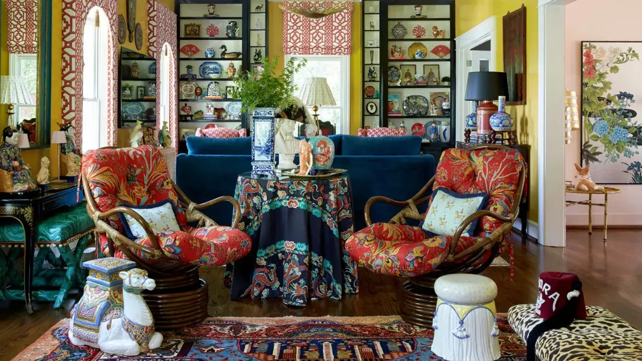 Two rattan chairs with vibrant patterned cushions are among the types of fancy chairs in this eclectic room, surrounded by decorative objects.