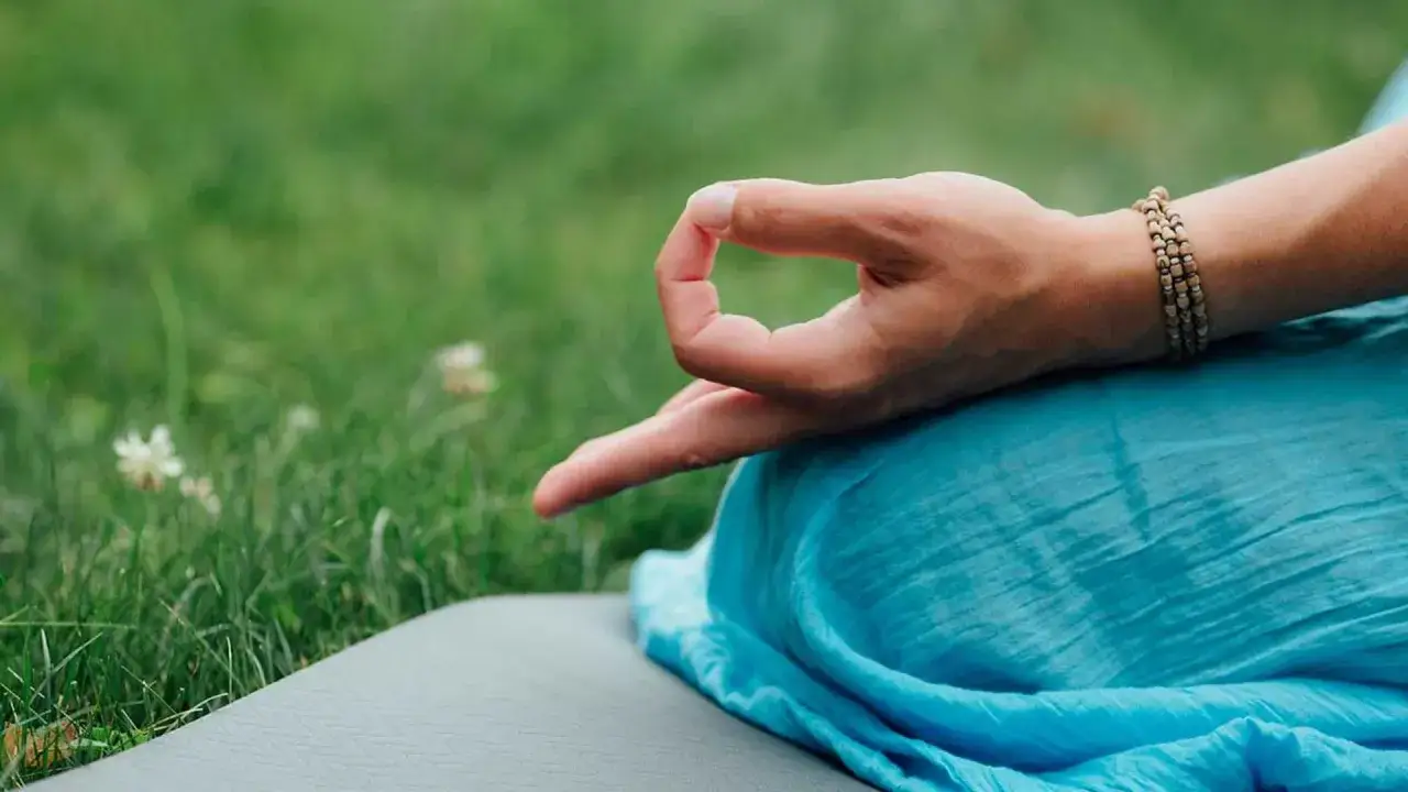 Mano en posición de meditación, con el pulgar e índice unidos formando un círculo, en un gesto namaste.