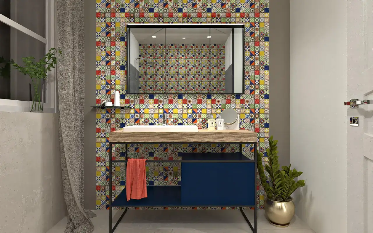 Un bagno moderno con un lavabo su un mobile blu scuro, incorniciato da un vivace **boxer mosaico** che riveste la parete.