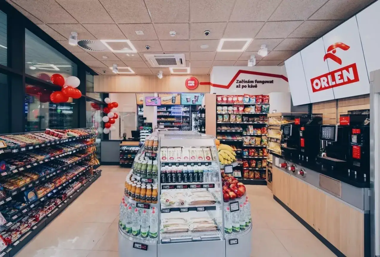 Sklep ORLEN oferuje szeroki wybór przekąsek, napojów i kawy. Czerwono-białe balony dodają uroku.