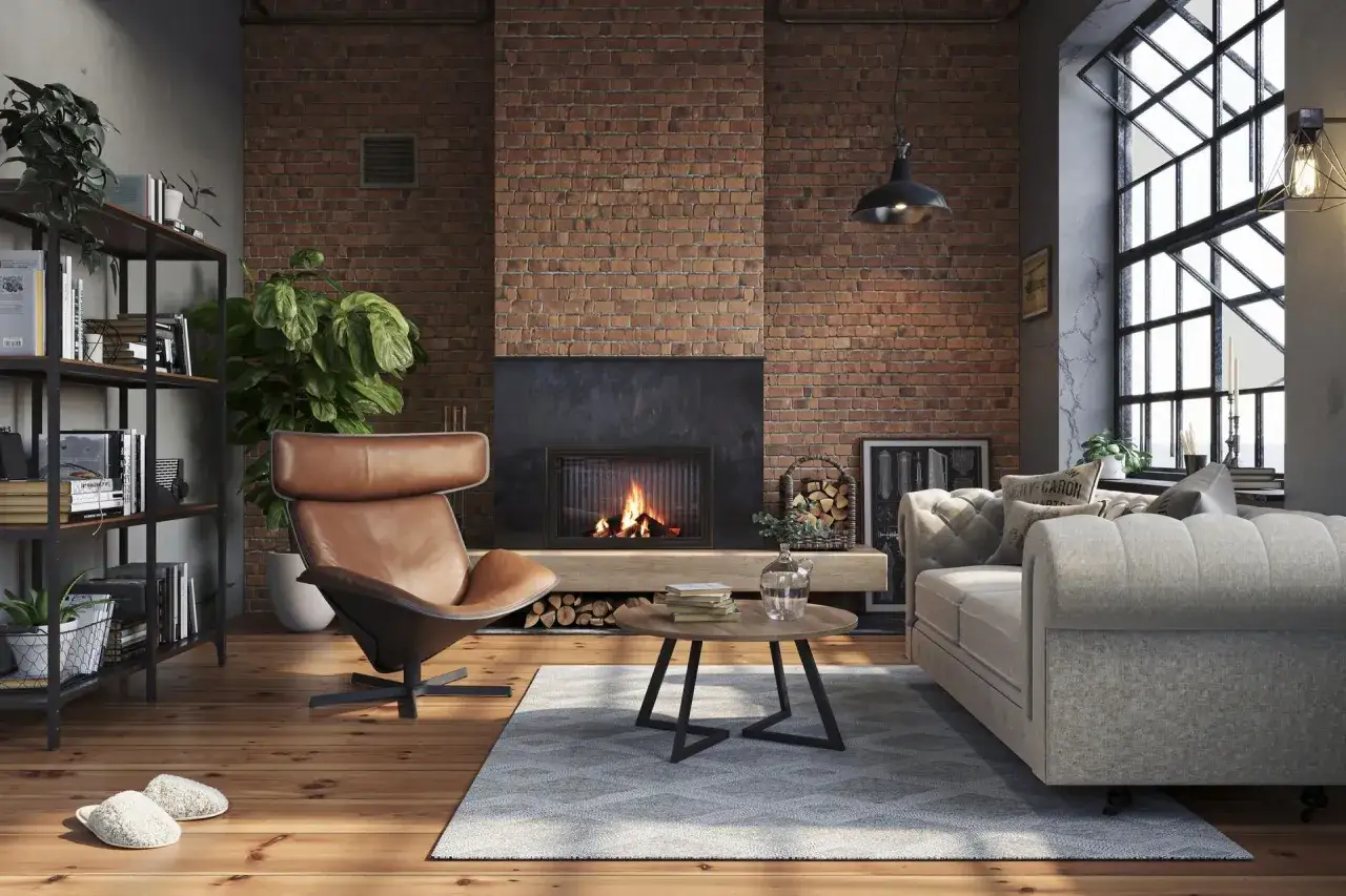 Przytulny salon w stylu industrialnym loft. Skórzany fotel, kominek z cegły i duża sofa tworzą ciepłą atmosferę.