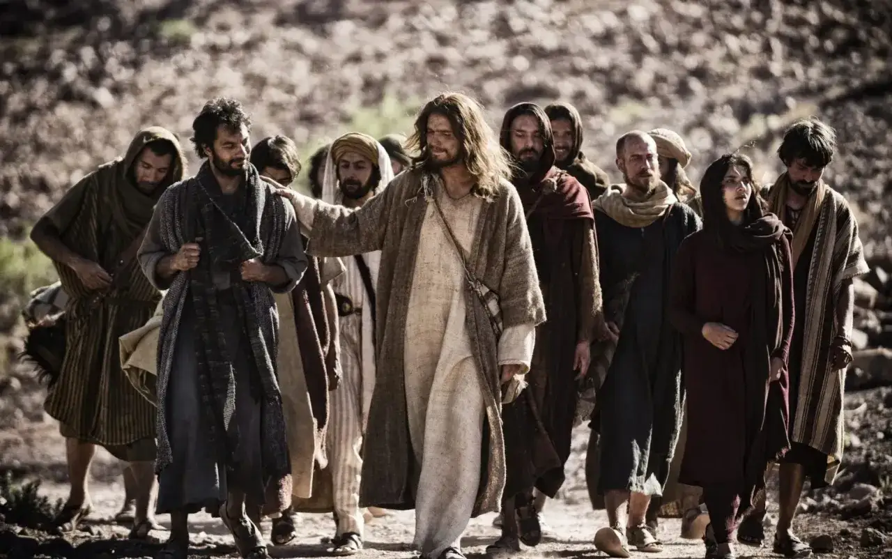 Jesus leads his followers, god's chosen people, through a rocky landscape. Their journey is marked by faith and shared purpose.