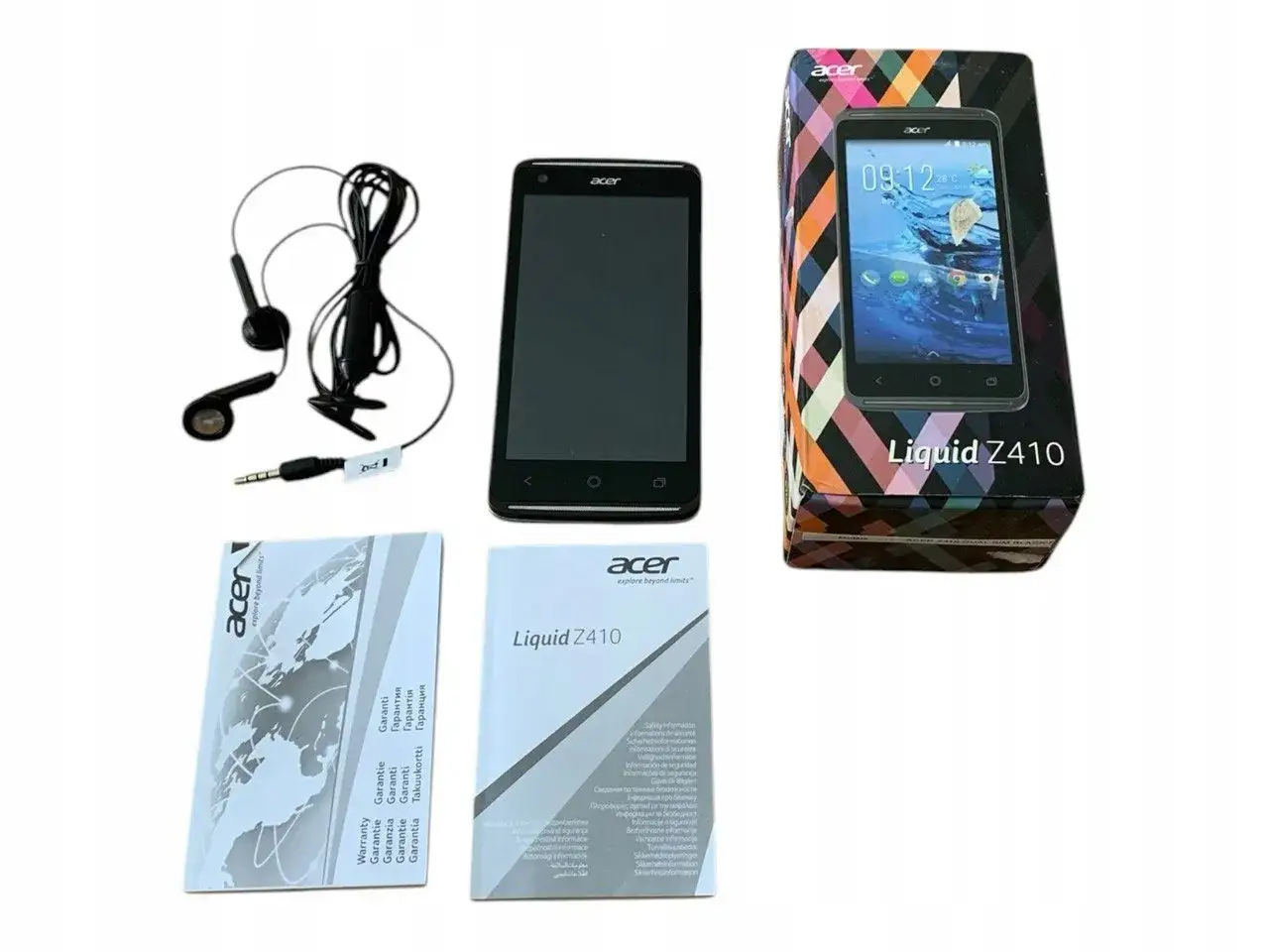 Telefon Acer Liquid Z410 z akcesoriami: słuchawki, instrukcje i pudełko.