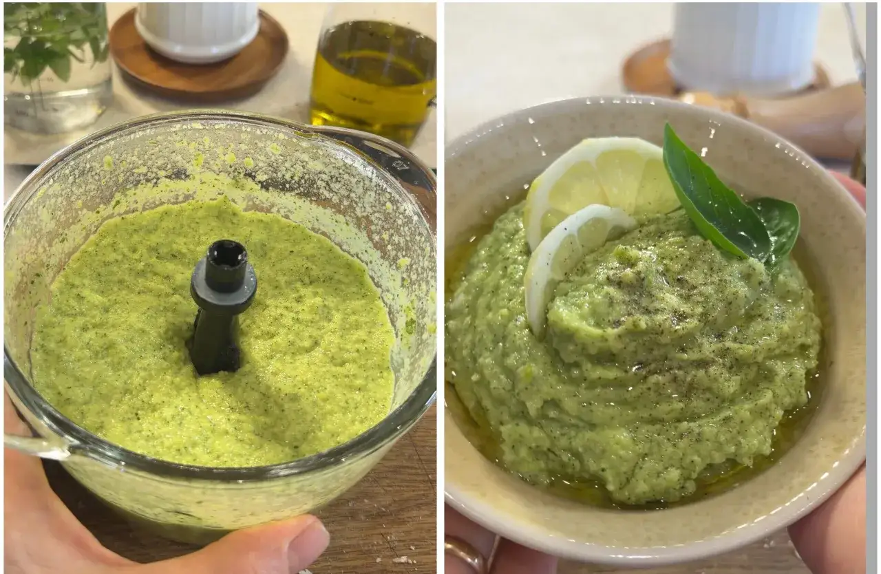 Pesto di zucchine appena frullato nel robot da cucina, pronto per essere servito in una ciotola con limone e basilico.