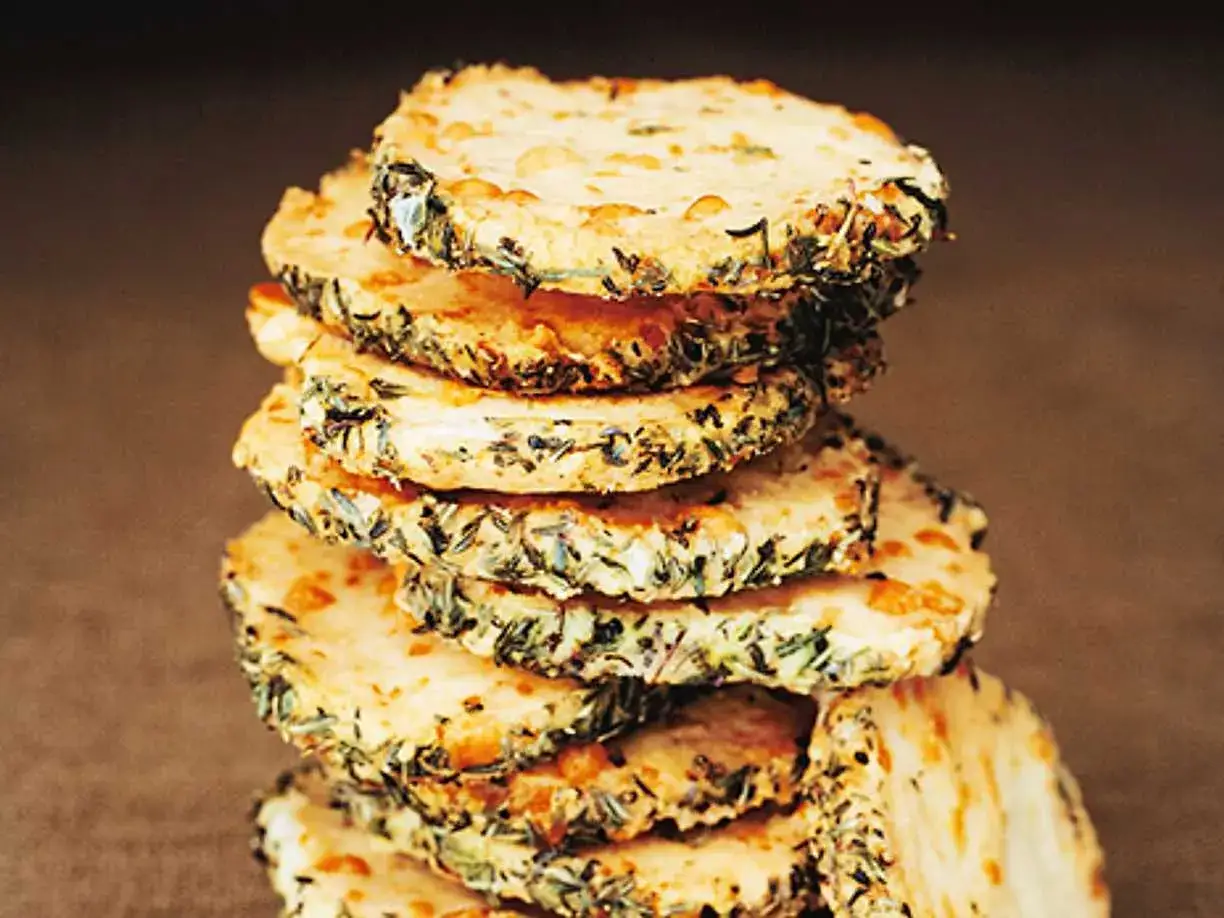 En stapel runda, gyllene parmesan kex med &ouml;rter p&aring; kanten. Perfekta tilltugg!