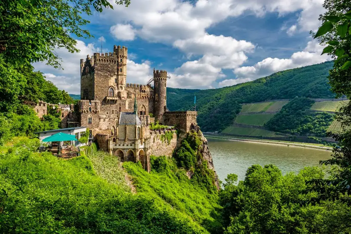 Burg Pfalzgrafenstein thront über dem Rhein. Perfekt für eine entspannte Rhein Fahrradtour mit Blick auf Weinberge.