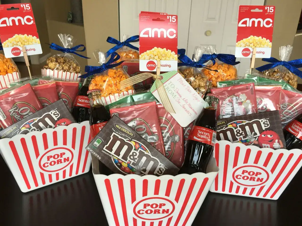 Movie night baskets with popcorn, candy, soda, and AMC gift cards, perfect raffle prizes for a fun evening.