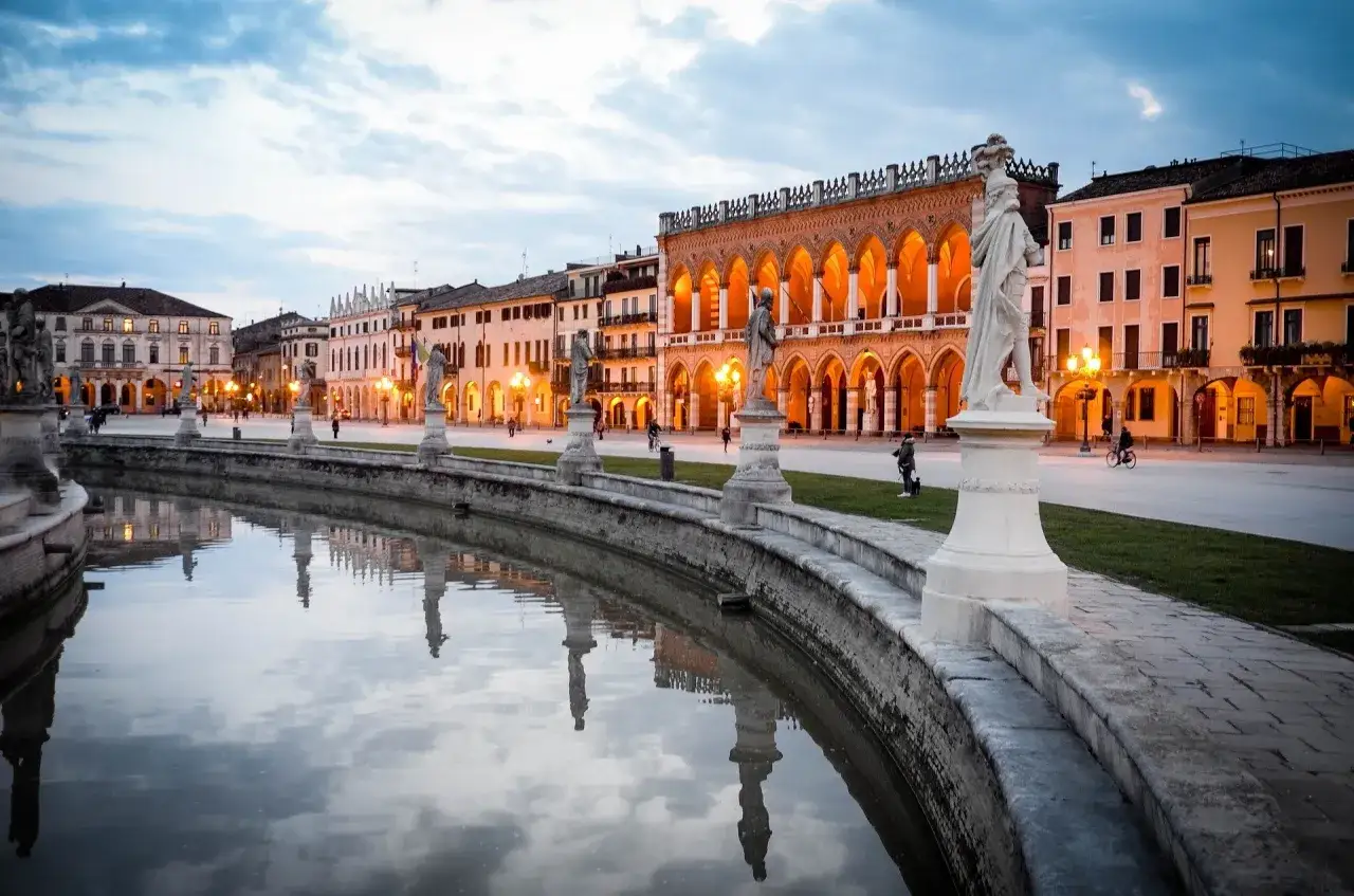 Piazza Prato della Valle a Padova, con statue e portici illuminati, ideale per scoprire cosa vedere a Padova in mezza giornata.