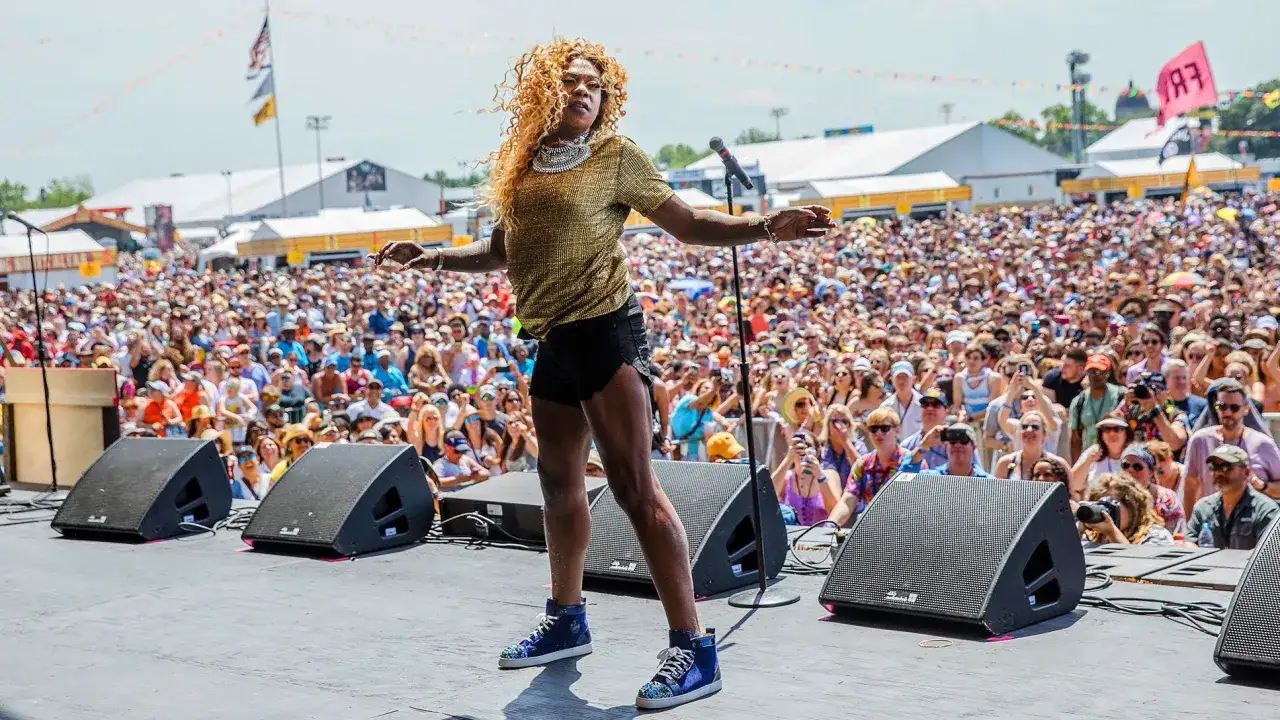 Big Freedia, a vibrant performer, commands the stage before a massive festival crowd. Her energetic presence hints at her impressive big Freedia net worth.