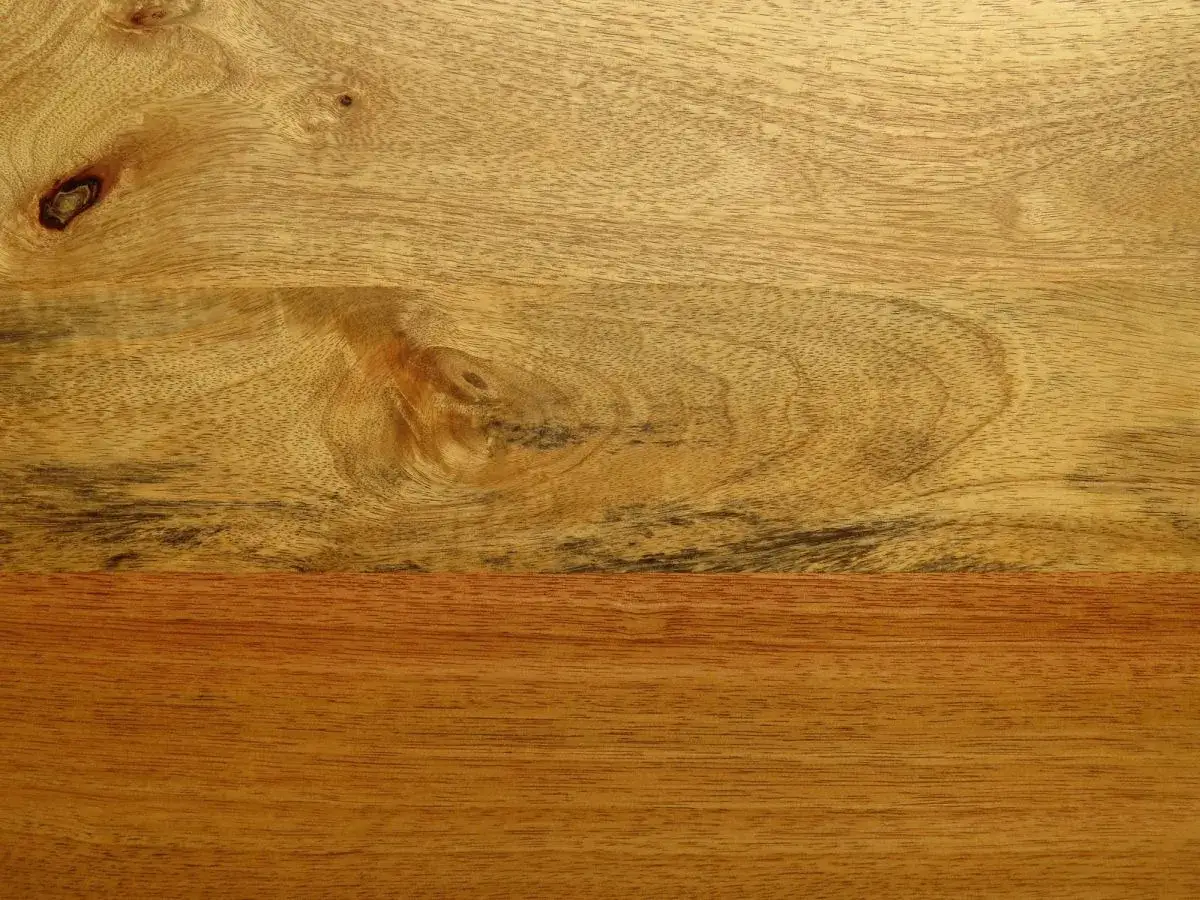 Close-up of a beautiful mango wood finish, showcasing natural grain patterns and knots.
