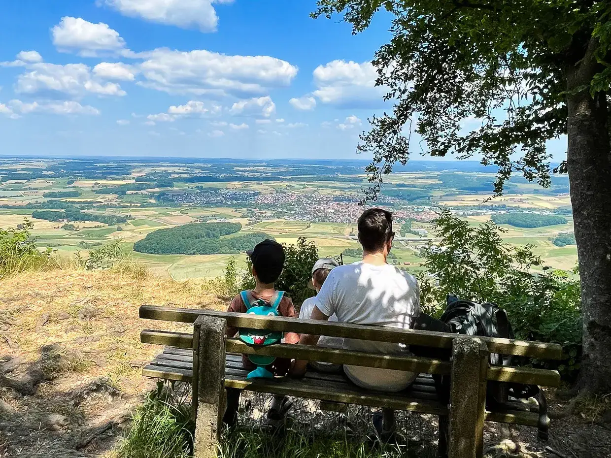 Familie genie&szlig;t den Ausblick vom Rosenstein bei Heubach auf die weite Landschaft.