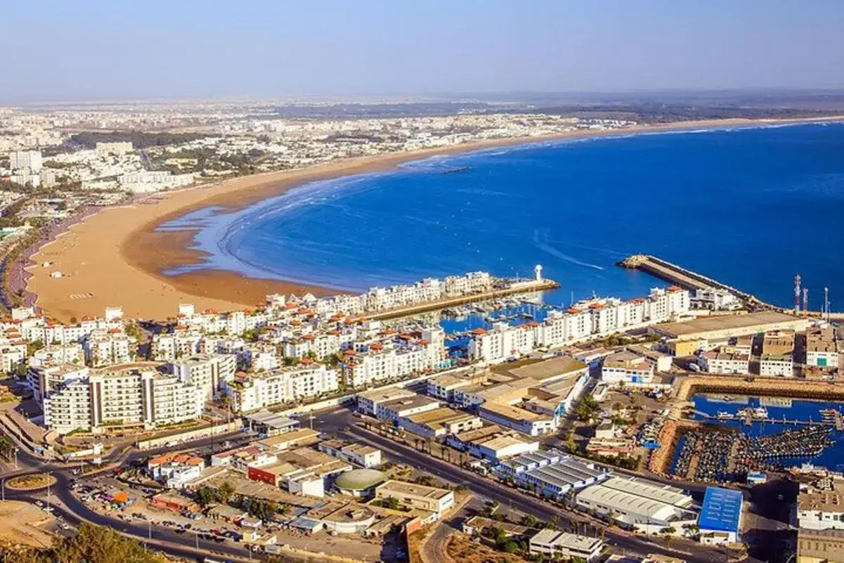 Agadir co zobaczyc: rozległa plaża, białe budynki, port jachtowy i rybacki, błękitne morze. Idealne miejsce na wakacje.