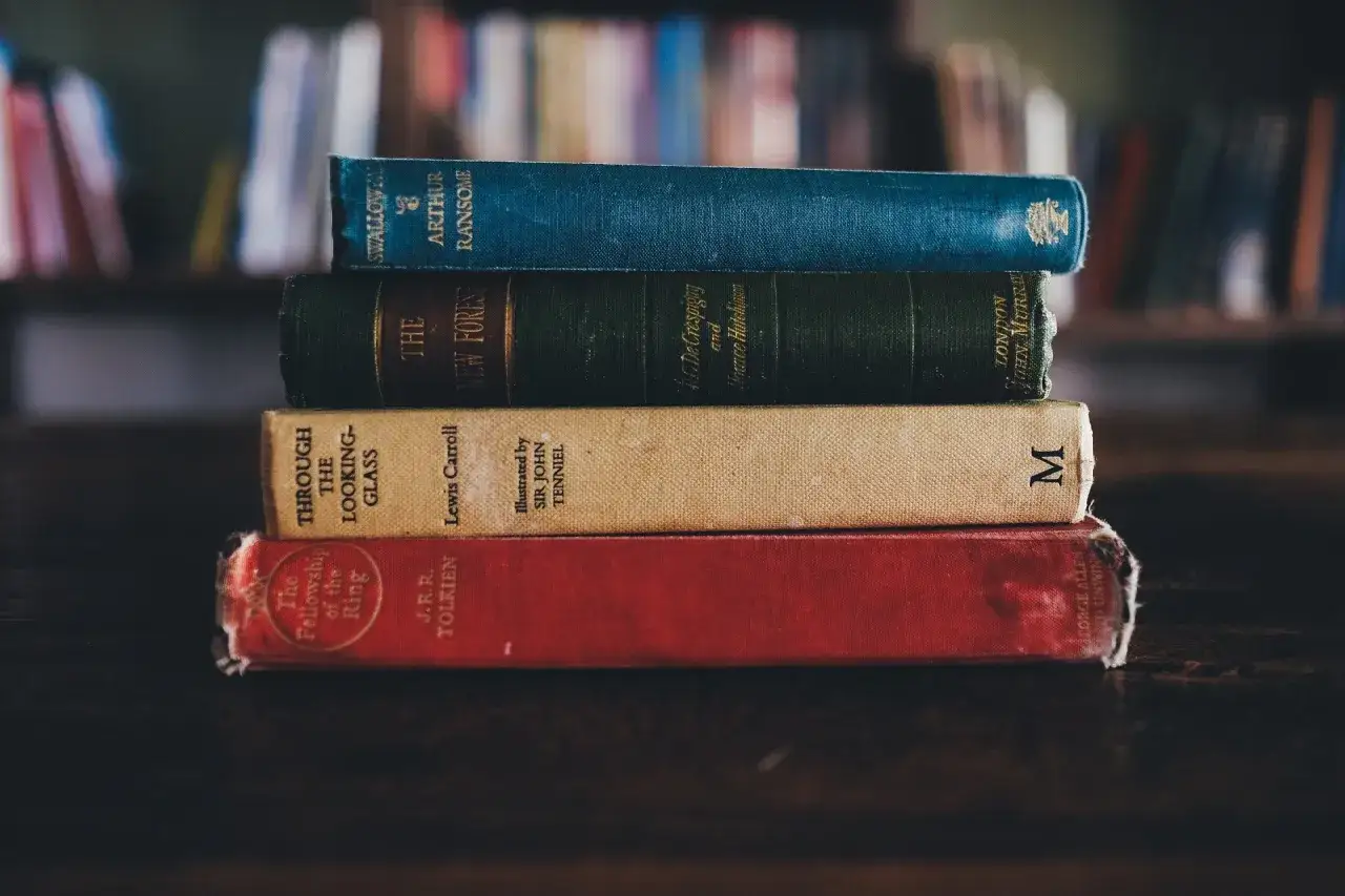 stack of classic books, diverse genres, old and new