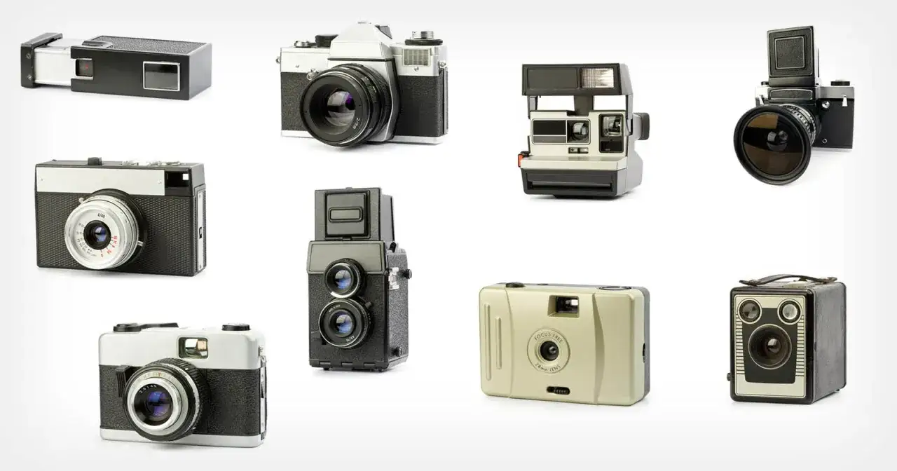 A collection of vintage film cameras, showcasing various designs from compact point-and-shoots to SLRs and instant cameras.