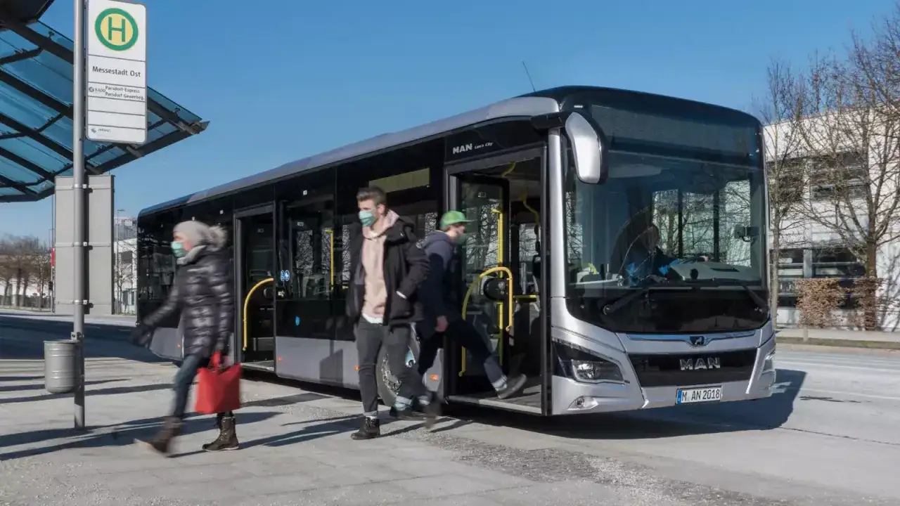 Des personnes montent dans un bus, illustrant la réglementation du transport interurbain de voyageurs.