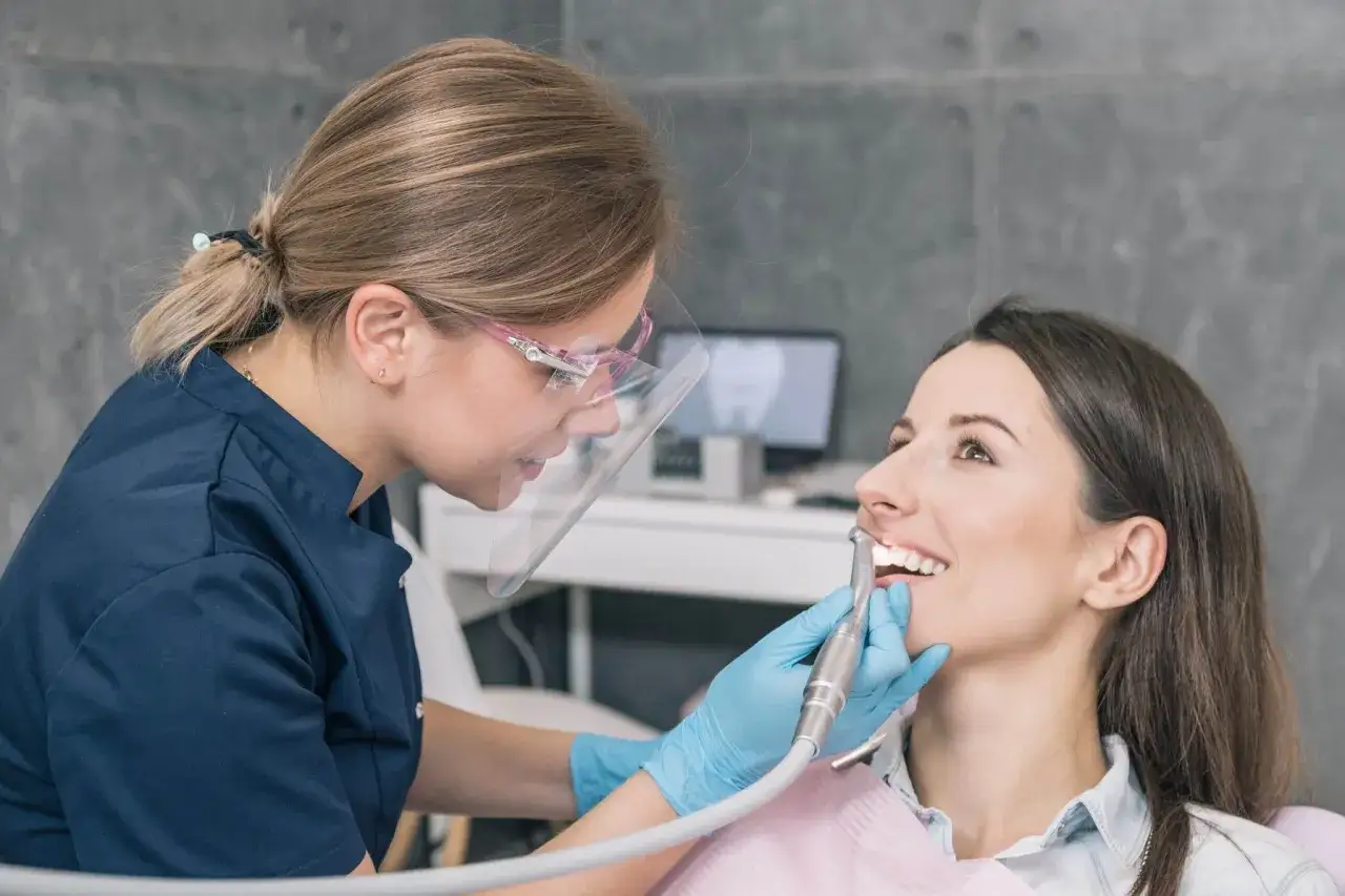 Dentystka leczy bardzo zepsute zęby pacjentki.