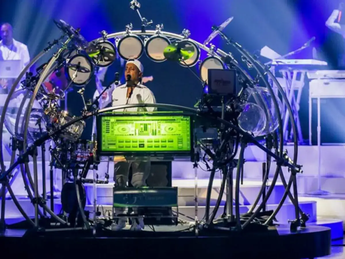 Artysta dj drum gra na futurystycznych bębnach w otoczeniu świateł.