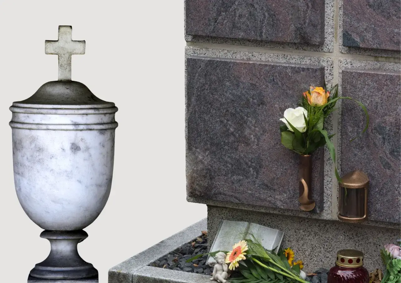 Kolumbarium i kwatera urnowa: różnica, koszty i estetyka. Marmurowa urna z krzyżem obok kamiennej ściany z kwiatami.